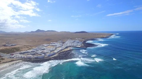4K Aerial view of ocean waves in sunny Lanzarote - Famara Surf Village Video stock 123469997