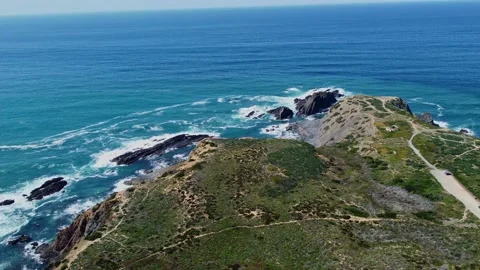 4K aerial view ocean waves crashing against rocky cliffs, sandy coast Portugal Stock Footage 238854375