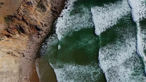 4K aerial view ocean waves rocky cliffs sandy coast, beach Portugal  2023 Video stock 239026574
