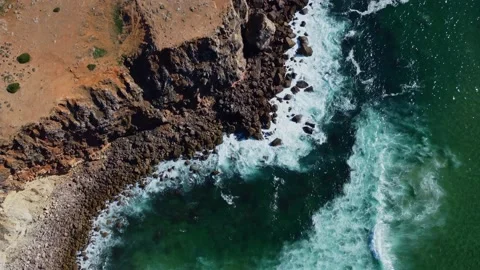 4K aerial view ocean waves rocky cliffs sandy coast, beach Portugal 2023 Video stock 239026842