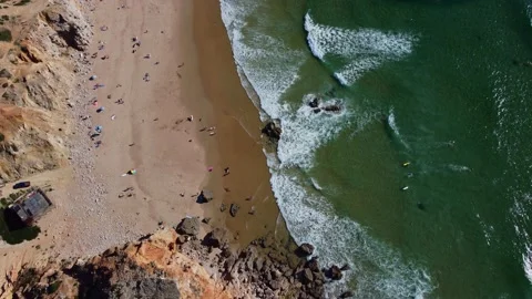 4K aerial view ocean waves rocky cliffs sandy coast, beach Portugal  2023 Video stock 239027142