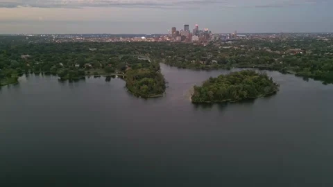 4K Aerial View Orbit Left Of Lake Of The Isles Islands And Minneapolis Skyline Stock Footage 220469834