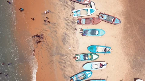 4k aerial view over fishing boats on sandy beach of Arugambay Stock Footage