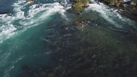 4K Aerial View over River Flow with  riverbank, waterfall and riverstones at day Stock Footage 90776786