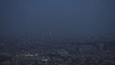 4K Aerial view of Paris with the Eiffel Tower illuminated at night - EDITORIAL Stock Footage 77193316