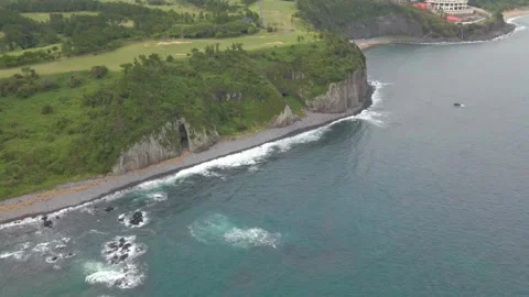 4K Aerial View Pulling Away from Gaetkkak Columnar Jointing, Jeju Island Stock Footage 143863138