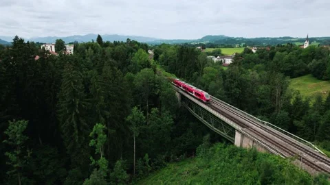 4k Aerial View of Red Train on Historic Bridge in Beautiful Green Landscape Stock Footage 236646889