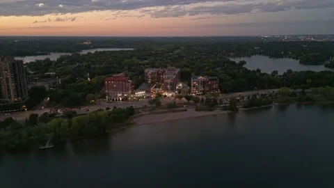 4K Aerial View Reverse From Buildings Near Lakes And Beach Minneapolis Sunset Stock Footage 220469832