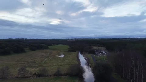 4K Aerial View of River Through Rural Fields Stockbeeldmateriaal 333926869