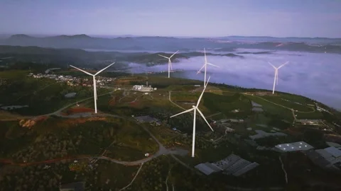 4K Aerial View Of Sea of Clouds and Windmills at Cau Dat Tea Hill, Vietnam Stock Footage 322561347