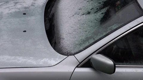 4K Aerial view snow fall on parked automobile in winter day snowy car windscreen Stock Footage 80068683