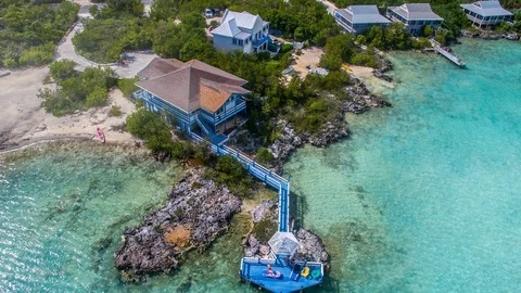 4k - Aerial view of some small house on the beach Stock Footage 72075560