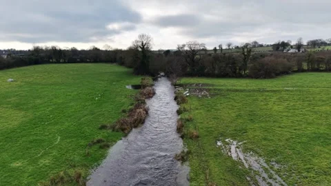 4K Aerial View of Stream Between Green Fields 스톡 동영상 332803170