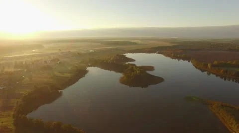 4K aerial view – sunset light over beautiful lake in autumn landscape Stock Footage 56165380