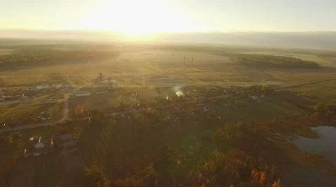 4K aerial view – sunset light over village and farmland – autumn landscape Stock Footage 56165383