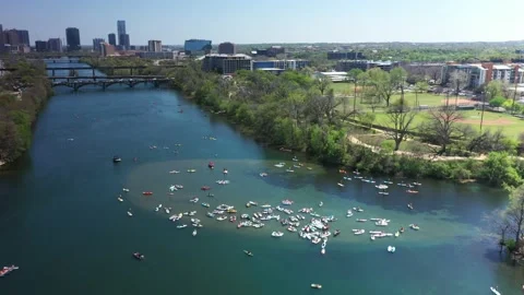 4K Aerial view SUP paddle boarders navigate Lady Bird Lake downtown Austin Texas Stock Footage 175017067