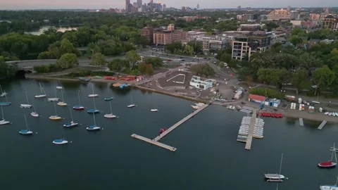 4K Aerial View Tilting Back Revealing Minneapolis Skyline Behind Sailing Center Stock Footage 220469626