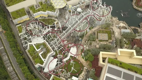 4K Aerial view of time lapse of roller coaster at Universal Studios theme park Stock Footage 107893771