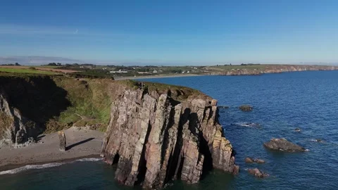 4K aerial view of Trá na mBó sea stack cliffs and coastal fields Stock Footage 332679176