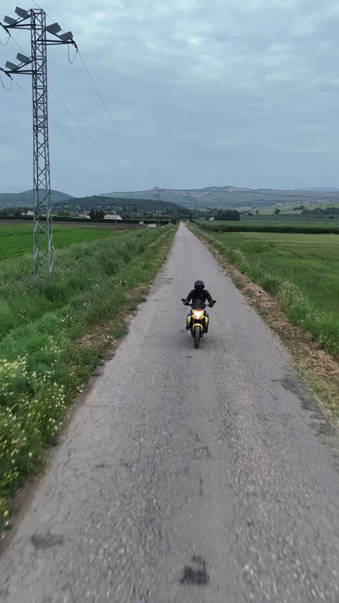 4K Aerial view tracking backward in front of a motorcycle riding in Spain Stock Footage 336205424