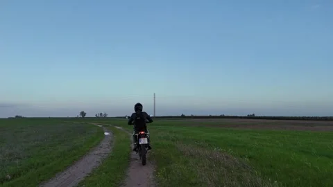 4K Aerial view tracking behind a motorcycle riding on a muddy path Spain Stock Footage 336205395