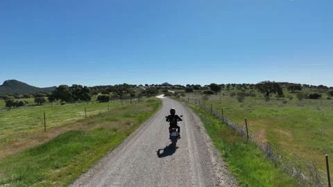 4K Aerial view tracking behind a motorcycle on a winding rural road Spain Stock Footage 336205403