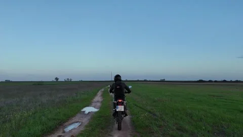 4K Aerial view tracking behind a motorcycle riding through puddles in Spain Stock Footage 336205417
