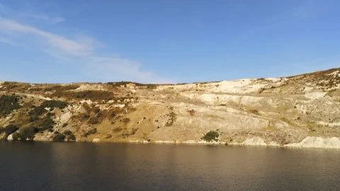 4K Aerial View Tracking Quarry Lakeside Bank In Great Sunlight Stock Footage 116040632