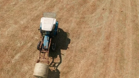4K Aerial View of Tractor Loading Bales on a Rural Devon Farm Stock Footage 112006396