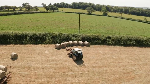 4K Aerial View of Tractor Loading Bales on a Rural Devon Farm Stock Footage 112329457