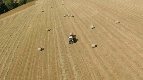 4K Aerial View of Tractor Sorting Bales in Rural Devon Video stock 112326781