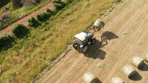 4K Aerial View of Tractor Sorting Bales in Rural Devon Stock Footage 112328541