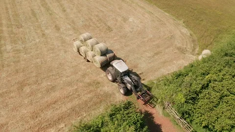4K Aerial View of Tractor Transporting Silage Bales in Rural Devon Stock Footage 112329312