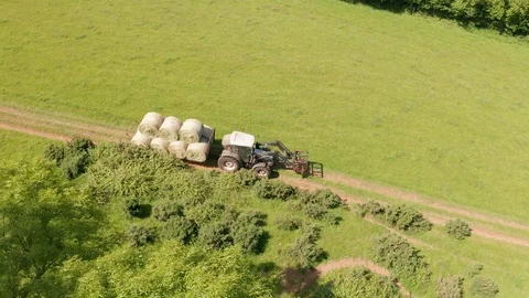 4K Aerial View of Tractor Transporting Silage Bales in Rural Devon Video stock 112329363