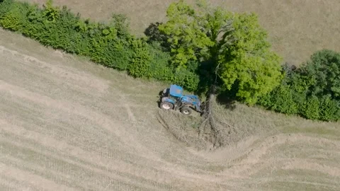 4K Aerial View of Tractor Working in a Field in Rural Devon Stock Footage 203515226