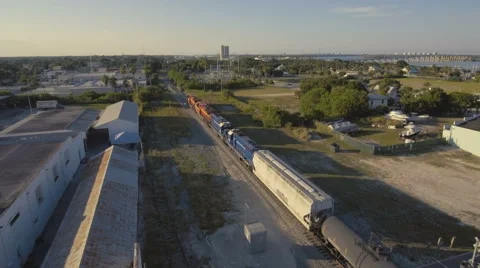 4K Aerial View of Train Going through Intercoastal Town Stock Footage 67559711