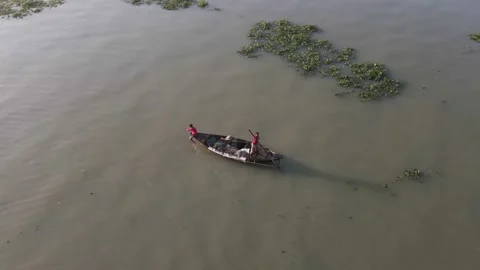 4K aerial view of two boy rowing a wooden boat Stock Footage 219880799