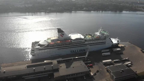 4k aerial view view around the cruise ship Tallink moored to the pier on river Stock Footage 112867219