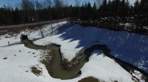 4k aerial winding stream flows in winter Stock Footage 61388503