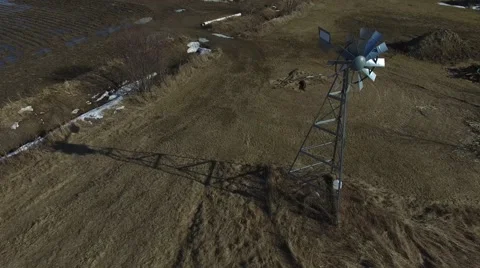 4k aerial windmill starts to spin in wind Stock Footage 61416183