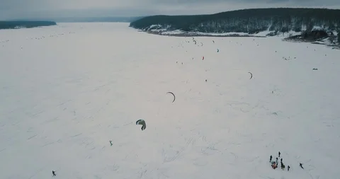 4K aerial winter extreme sport snow kiting competition race with different Stock Footage