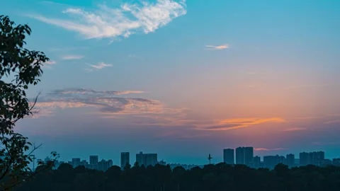 4K Aesthetic Time-lapse of Sunset Glow with Silhouettes of Urban High-rises Stock Footage 341788522