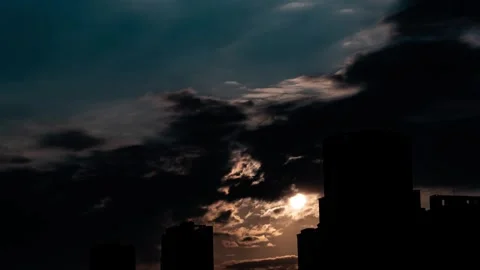 4K Aesthetic Timelapse: Clouds Drift Over Sun, City Skyscraper Silhouettes Stock Footage 341788520