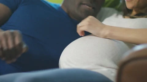 4K Affectionate pregnant couple relaxing at home on the sofa. Stock Footage