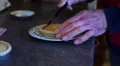 4K aged caucasian man's hand cuts up bakewell tarts/cakes on pretty plate 4k or 4k+ Resolution