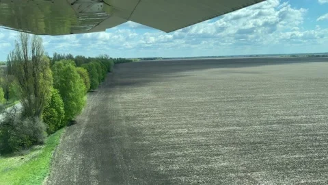4k Airplane flying over the fields and the road with cars. Stock Footage 155805952