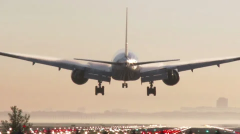 4K Airplane landing at sunrise, tracking shot Stock Footage 37498399