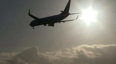 4K Airplane passing sun at sunset Stock Footage 34762085