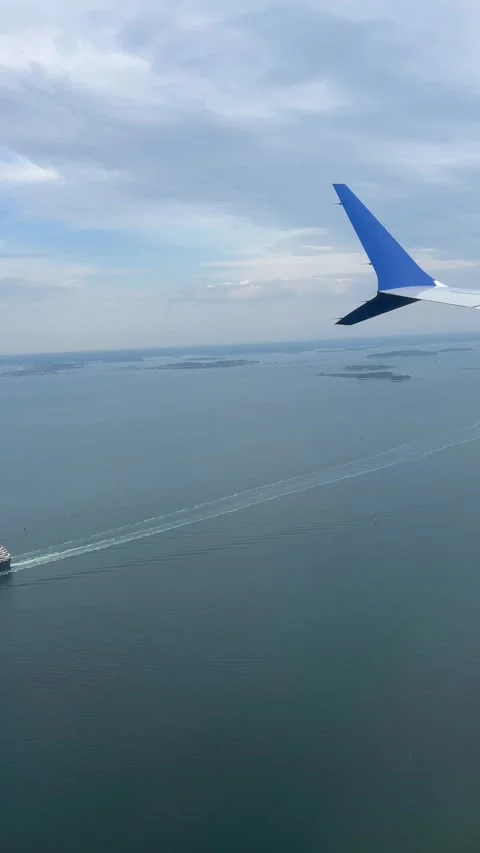 4K Airplane Window View Above Cruise Ship Vertical POV Stock Footage 337202932