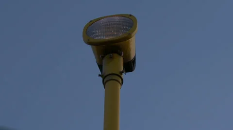 4K airport lamp post with passing airplane Stock Footage 34789731